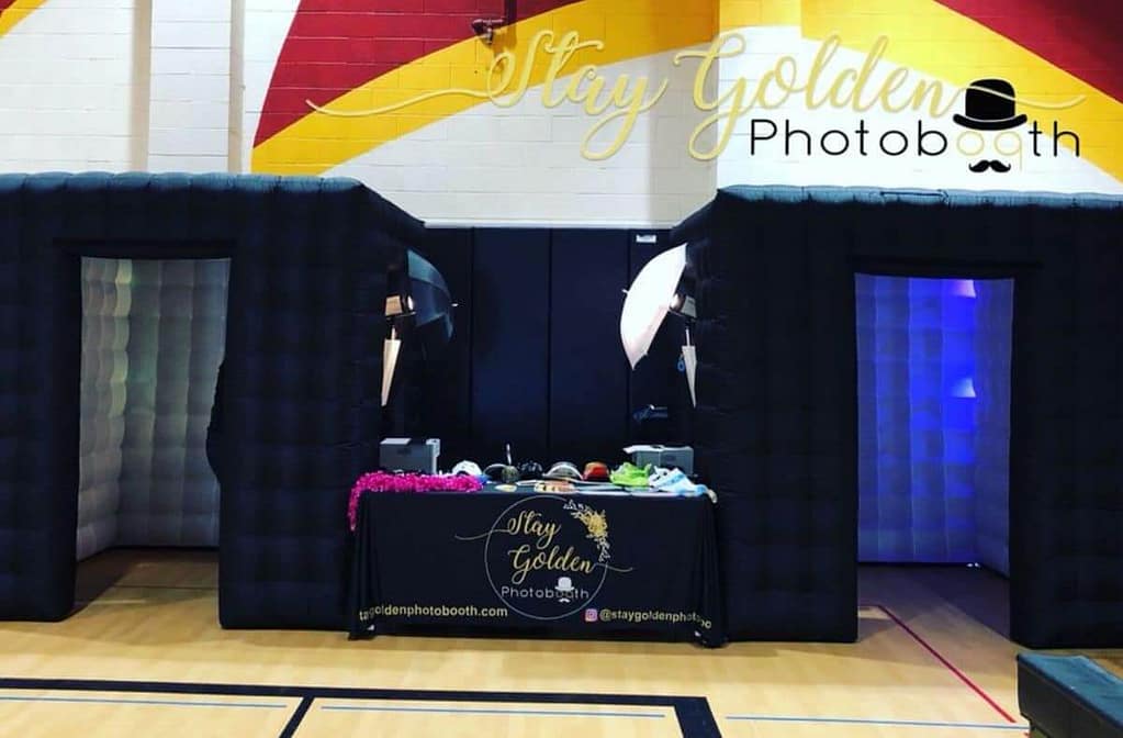 Enclosed Photo Booth setup with props and lighting by Stay Golden Photo Booth