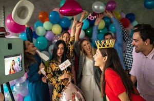 friends and relatives taking a picture from a photo booth set up