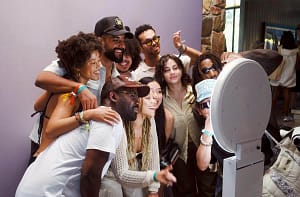 friends and relatives taking a photo from a photo booth at an event. Photo by Barry Wong
