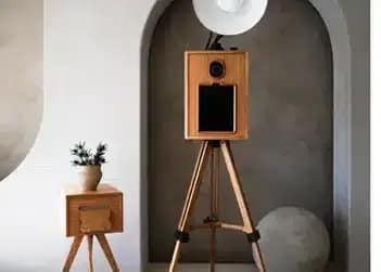 Our Glam Photo Booth rental features a sleek wooden design, perfect for elegant and modern events.