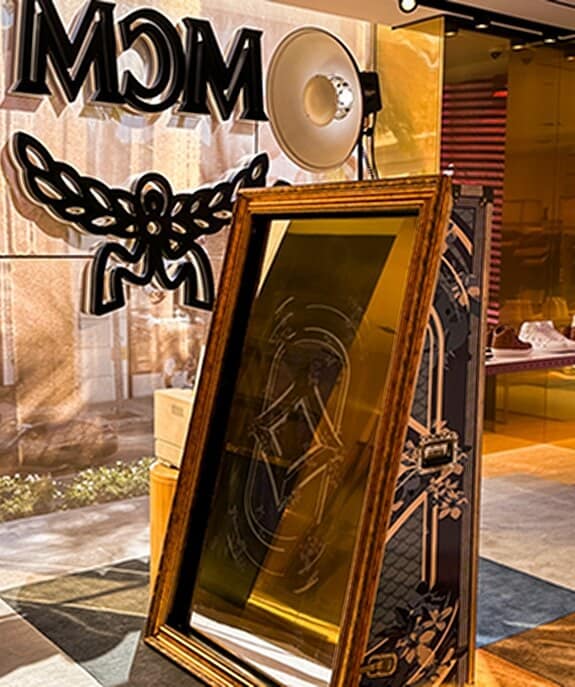 Our Mirror Photo Booth Rental set up at an upscale event, featuring a sleek touch-screen and interactive mirror design.