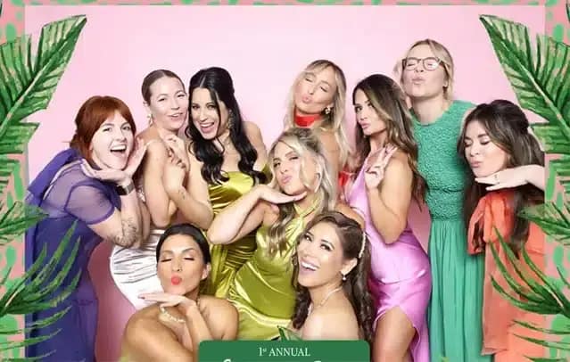 Group of stylish ladies posing in a photo booth at the 1st Annual Curate Gala corporate event.