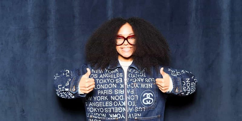 Stylish smiling lady in denim outfit at Flyana Boss photo booth rental in Chula Vista