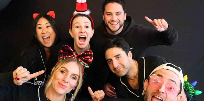 Service Titan colleagues posing with festive props at a holiday photo booth rental in Irvine.