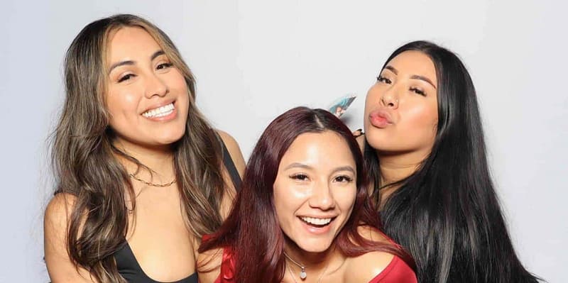 Three ladies pose and smile at an event with a photo booth rental in San Dimas, LA.